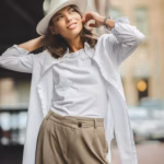 photo-woman-hat-poses-street-against-buildings_257482-1010